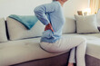 © Jelena Stanojkovic - Tired upset elderly woman feeling strong lower back pain after sleeping in incorrect posture on uncomfortable mattress. Senior 60s lady with closed eyes sitting on bed, holding painful lumber muscles.