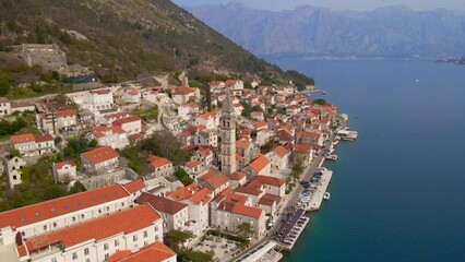 Wall Mural - Aerial video. The view of the city of Perast. In the center of the city, the Bell Tower in the church of Saint Nikolas is located. Travel to Montenegro concept