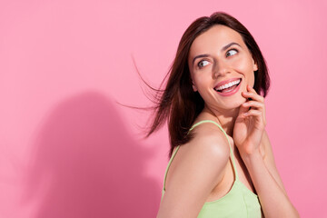 Sticker - Photo of shiny dreamy young girl dressed green outfit wind blowing looking back empty space isolated pink color background