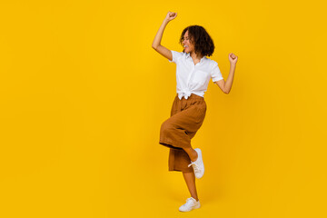 Sticker - Full body photo of satisfied positive girl raise fists celebrate luck success isolated on yellow color background