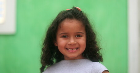 Wall Mural - Brazilian child smiling. hispanic kid girl smile