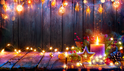 Wall Mural - advent - candle glowing in christmas lights on wooden table with decoration - defocused bokeh and gl