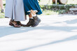 © PicsArt - Pieds de deux femmes en robe en train de faire une danse folk dans un bal