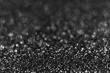 Wall Mural - Gray black sparkling glitter bokeh background, christmas abstract defocused texture. Holiday lights. Snowy shiny sparkle stars for celebrate