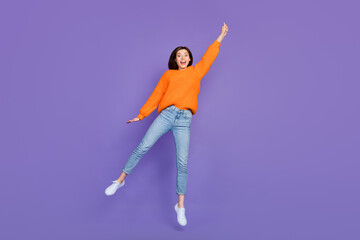 Wall Mural - Full length photo of lovely young lady hang invisible umbrella wear trendy orange knitwear clothes isolated on violet color background