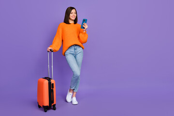 Poster - Full length photo of charming young lady hold telephone gps maps wear trendy orange knitwear clothes isolated on violet color background