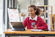 © David - Young businesswoman cheerful african american lady working at workplace office, workdesk with laptop financial documents having phone conversation, copy space