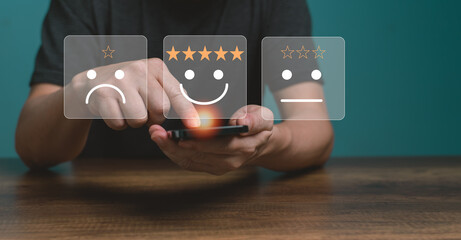 Wall Mural - Customer service and Satisfaction concept ,Business people are touching the virtual screen on the happy Smiling face icon to give satisfaction in service. rating very impressed. 