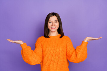 photo portrait of nice young lady palms scales compare product dressed stylish knitted orange outfit