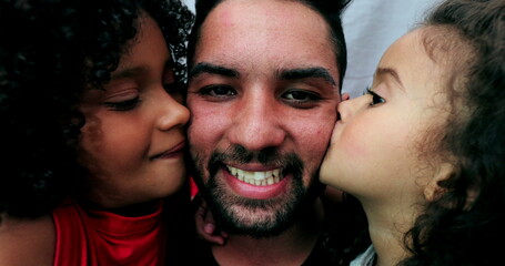 Wall Mural - Hispanic father kissed by two daughters. latin south american people affection