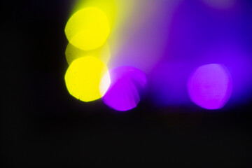 Wall Mural - Stage lighting. Spotlights with colored lights on a stage. Artificial lighting. Black background and blur.