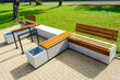 © Zigmunds - New modern design outdoor infrastructure object, wooden plank rest benches with a concrete base