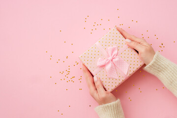 Wall Mural - Woman giving present box on pink background. Boxing day. Top view with copy space.