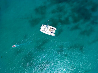 Wall Mural - Aerial drone of luxury yachts anchored in tropical exotic island with crystal clear turquoise sea and 