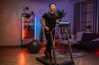 © sofiko14 - Attractive young sports asian man doing fitness exercise, running on treadmill . Athletic and muscular male having actively workout indoor, at modern apartment at night time at home.