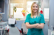 © Bojan - Young beautiful female dentist standing in dental office wearing uniform.