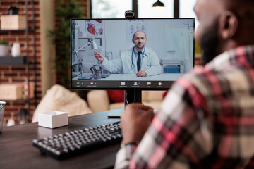 Wall Mural - Adult talking to medic on telehealth videocall, using telemedicine videoconference with webcam to meet with medic and talk about healthcare consultation. Online remote teleconference call.