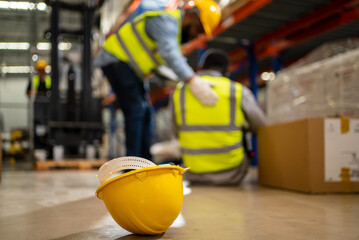 Wall Mural - Factory Accident, Industrial accident. Warehouse staff having accident in the factory, industrial worker injured during working having pain on leg, worker helping and giving the injured first aid