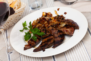 Wall Mural - Delicious fried liver pork with fried onion at plate