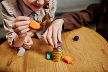 Close Up Of Children Stacking Chocolate Coins While Playing Jewish Dreidel Game, Copy Space