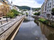 Karlove Vary Chech fountain, river and white road with trees