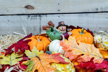 Fall, Autumn Pumpkin Arrangement With Adorable Scarecrow Figurine On Top.