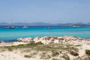 Wall Mural - Rocky beach with a turquoise blue sea and waves in spain