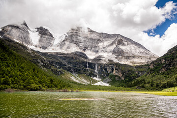 The snow mountain and beautiful emerald green lake of Daocheng Yading in Sichuan, China, Horizontal image, copy space for text