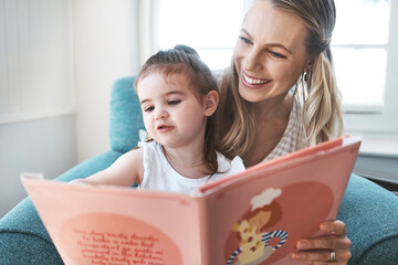 Wall Mural - Book, family and love with a mother and daughter reading a story on a couch in the living room of their home together. Children, love and education with a woman and daughter bonding over a storybook
