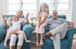 © Allistair/peopleimages.com - Happy grandparents, children and smile in relax for family bonding time together in the living room at home. Portrait of grandma, grandpa and little girls smiling in playful happiness for free time