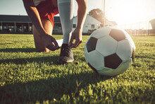 Fitness, Shoes And Soccer Player Ready For Sports Training, Exercise And Cardio Workout On Football Field Outdoors. Hands, Footwear And Athlete Tying Boots To Start A Practice Game Or Match