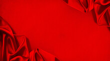 Red Silk Satin. Beautiful Soft Folds. Shiny Fabric. Bright Luxury Background. Space For Design. Christmas, Birthday, Valentine Day, Valentine, Mother's Day, Festive. Banner. Flat Lay, Table Top View.
