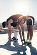 © Allistair F/peopleimages.com - Stretching, fitness couple or outdoor personal trainer runner friends on lens flare, summer blue sky mock up for workout motivation. Sports coaching, flexibility and exercise warmup training people