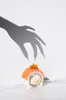 Sushi Halloween on white background. Maki roll with witch hand shadow. Creative party food. Spooky, scary, fun, bewitched California with salmon. Japanese sushi bar, restaurant holiday menu. Vertical