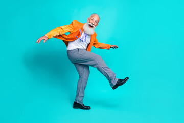 Sticker - Full length photo of sweet funny pensioner guy wear neon orange jacket dancing disco walking isolated teal color background