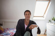 © Caia Image - Portrait confident mature woman in sunny bedroom