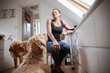 © Caia Image - Dogs and happy woman in home office