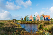 Small Colorful Houses Next To Historic Windmill In Dutch Town Of Volendam, North Holland