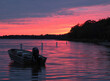 Small Boat Anchored on Muskellonge Lake, Michigan During a Beautiful Pink, Purple and Orange Sunset