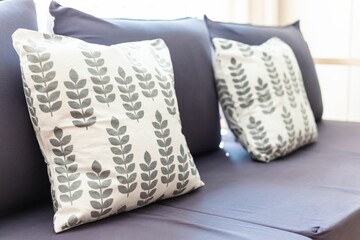 Wall Mural - Set of white botanical pillows with leaves on a blue couch