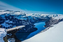 Aerial Shot Of Snowy Mountains And Gorges With A River In The Middle In Trolltunga, Norway