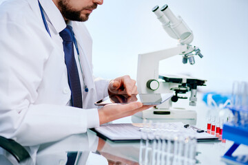 close-up. scientist reading notes in his digital tablet.