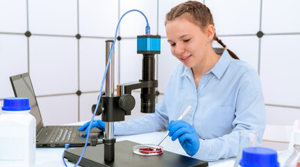 Poster - young woman scientist in crystallography laboratory studying crystals under electron microscope