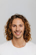 © Drobot Dean - Ginger european man with curly hair smiling and looking at camera