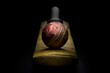 Red leather cricket ball on a cricket bat front view