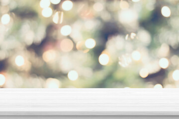 empty wood table top with blur christmas tree with bokeh light background