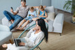 family with their devices spends the evening in a cozy living room .