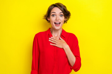 Wall Mural - Portrait of pretty impressed girl hand touch chest open mouth cant believe isolated on yellow color background