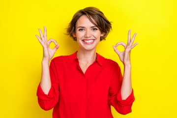 Poster - Portrait of girlish nice adorable lovely woman with bob hairstyle wear red shirt showing okey symbol isolated on yellow color background