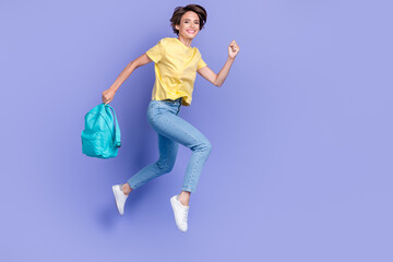 Poster - Full body portrait of excited energetic lady hold bag jumping running isolated on purple color background